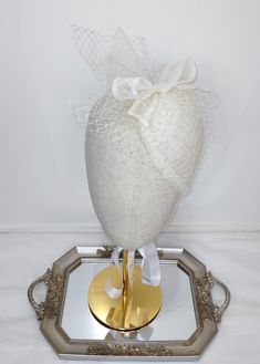 100% Sinamay straw ivory off-white  teardrop fascinator percher hat, vintage inspired with French veiling and sinamay bow. Length of 6 inches (15.25 cm), Width of 4.75 inches (12 cm). Cute, dainty and feminine hair accessory. Hair comb attached. Wear this ivory off-white  fascinator hat for any special occasions, weddings, bridal showers, tea parties, Church, Kentucky Derby, Royal Ascot, Queen's Plate, any race day or fashion event. Elegant Cream Party Veil, Vintage White Wedding Costume Hats And Headpieces, White Vintage Wedding Costume Hats And Headpieces, White Vintage Headpieces For Formal Occasions, White Vintage Headpiece For Formal Occasions, Gatsby Style Summer Wedding Fascinator, Vintage White Costume Hats And Headpieces For Wedding, Fitted White Ceremony Headpiece, Fitted White Headpiece For Ceremony