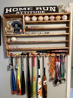 a rack with baseballs, bats and medals on it