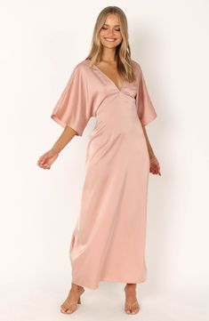 Drapey dolman sleeves frame a smooth satin maxi dress fashioned with a gracefully dipped back and attached waist ties. Slips on over head Deep V-neck Elbow-length sleeves Attached waist ties Unlined 100% polyester Hand wash, dry flat Imported Dolman Sleeve Maxi Dress, Petal And Pup, Eliza Dress, Resort Dresses, Essential Dress, Usa Dresses, Satin Maxi, Satin Maxi Dress, Pink Maxi Dress