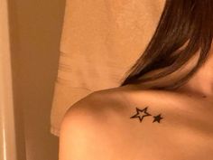 a woman's shoulder with three stars tattoo on her left shoulder and right arm