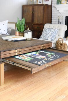 a coffee table with an open drawer underneath it on a hard wood floor in a living room