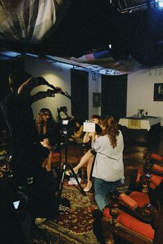 a group of people sitting around in a room with microphones and lights on the floor