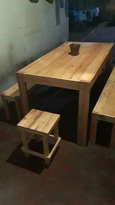 a wooden table and two benches in a room