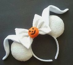 a white headband with an orange pumpkin on it