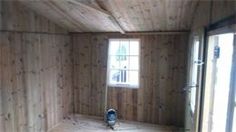 an empty room with wood paneling on the walls