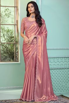 Turn heads at any celebration with this stunning Party Wear Saree, a true masterpiece of elegance and craftsmanship. Draped in exquisite fabric, this saree features intricate border work that adds a touch of sophistication and charm. The highlight is the meticulously designed embroidery blouse, which complements the saree perfectly, creating a harmonious and eye-catching ensemble. Shimmer Saree, Peach Color Saree, Simple Saree Designs, Fancy Sarees Party Wear, Simple Sarees, Saree Designs Party Wear, Party Wear Saree, Sequin Embroidery, Trendy Sarees