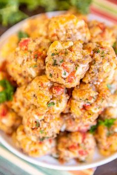 a white plate topped with meatballs covered in sauce and garnished with parsley