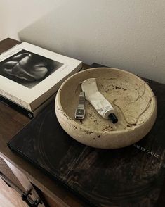 a table with a book and a bowl on it