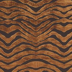 an animal print area rug in brown and black colors with wavy lines on the surface