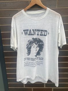 "Vintage 1980s Jim Morrison Wanted T- Shirt  - Missing Tag (Length 29.5\", Chest 22\") - Fits like a LARGE - Sourced from the original owner! - Overall great vintage condition (flaws pictured) - Message for more information Please take note of the measurements listed as these are vintage clothes and may fit different than the tag size. Follow our page for more vintage clothing drops!" The Doors T Shirt, The Smiths Graphic Tee, Jim Morrison Tshirt, Talking Heads Shirt Vintage, Vintage Metallica Shirt, Jim Morrison, Band Tees, 1980s Vintage, Like New