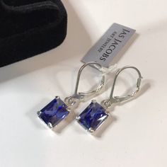 Beautiful Emerald Cut Tanzanite* & Sterling Silver Leverback Earrings * Emerald Cut Tanzanite* measure 8mm x 6mm each * 3cts total gemstone weight * Solid Sterling Silver * Measure 1 inch Long overall * Leverback fastening Hallmarked & Gift Ready! Matching Pendant Necklace and/or Ring also Available *Tanzanite is one of very few gemstones that cannot be grown in a Lab, however, these Laboratory Grown Simulate Stones are optically identical to a natural Tanzanite in color and are just as Trillion Cut Earrings, Luxury Diamond Jewelry, White Sapphire Earrings, December Gift, Green Amethyst Earrings, Pink Sapphire Earrings, Earrings Emerald, Tanzanite Earrings, Fine Art Jewelry