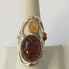 This Sterling Silver Amber Ring Is A Beauty! It Has 2 Amber Stones And A Very Nice Light Amber Stone As Well. It Is Approx. 1 1/2” High And Approx. 1 1/4” Wide. As With All My Items, Unless Otherwise Stated, This Is New Never Worn. I Reply To Questions Via Poshmark “Comments” Only, Not To Private Email/Text. Thank You. Green Amber Ring, Shifting Closet, Rose Gold Opal Ring, Artistic Ideas, Moon And Star Ring, Unusual Rings, Amber Crystal, Peridot Stone, Amber Ring