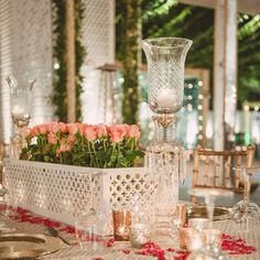 a table with flowers and candles on it