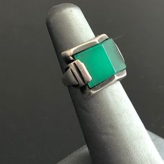 "What a great Art Deco ring! The chrysoprase stone is stunning in shape and translucence. Chrysoprase has been a choice stone in some of the best jewelry styles, from Art Nouveau (Georg Jensen featured it often) to Scandinavian Modern (it was a favorite of mid-century artists from Denmark, Finland, Norway, and Sweden.) In the Art Deco era, chrysoprase enhanced pieces from affordable marcasite silver jewelry to luxurious diamond-studded platinum pieces by makers like Cartier. This chrysoprase has Vintage Turquoise Gemstone Ring For Formal Occasions, Vintage Turquoise Ring For Formal Occasions, Vintage Green Opal Ring For Anniversary, Green Modernist Rings For Anniversary, Antique Green Emerald Ring With Polished Finish, Vintage Green Emerald Cut Jewelry, Classic Green Jewelry With Large Stone, Modernist Green Rings For Anniversary, Vintage Green Opal Ring