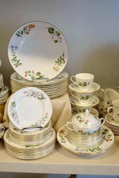 a table topped with lots of plates and bowls