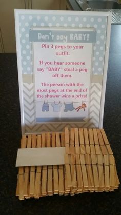 a baby shower game with clothes hanging on the line and instructions to put in it