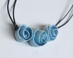 two necklaces that have been made to look like roses