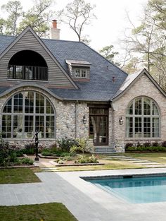 a house with a pool in front of it