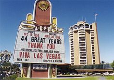 a sign in front of some tall buildings that say, thank you via las vegas