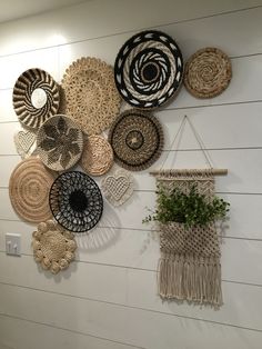 several woven baskets hanging on the wall