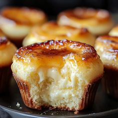 there are some cupcakes that have been cut in half on a black plate