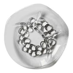 a white plate with some silver balls on it