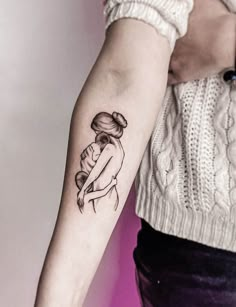 a woman with a tattoo on her arm