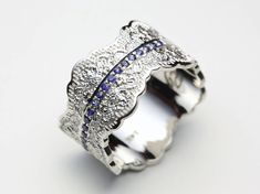 "14K Gold Lace Ring with Blue Sapphires. We are proud to announce that this ring design was selected as one of 15 Creative Products of the Month (February 2017) by the MyModernMet art blog! http://mymodernmet.com/most-creative-products-february-2017/ ❤ This unique wide made-to-order ring is crafted with an intricate lace pattern and twenty-one gorgeous natural blue sapphires set in the middle. The ring measures approximately 12 mm wide. The ring can be made in 18K or 14K yellow gold, 14K rose go Luxury Sterling Silver Sapphire Wedding Ring, Sapphire Jewelry With Single Cut Diamonds For Wedding, Elegant Sapphire Filigree Wedding Ring, White Gold Engraved Wide Band Wedding Ring, Luxury Sapphire Ring With Round Band For Wedding, Blue Sapphire Ring With Single Cut Diamonds For Wedding, Luxury Sapphire Wedding Ring With Round Band, Wedding Rings With Single Cut Diamonds And Sapphire, Luxury Promise Ring With Decorative Band