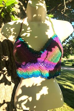 Summery hand-crocheted festival halter top in cool rainbow shades, ready to ship!  Just made for concerts, festivals, the beach, and anywhere else a pretty boho/hippie/vintage-vibe top belongs!  Made of a soft acrylic-blend yarn with a matching blue glitter thread for extra sparkle!  Created in a smoke-free home.  Each top is a unique work of art--this listing is for the one pictured.    Pattern is "The Bea" by the talented girliescrochet.com Measurements  -  One size fits most.  Crochet stretches a bit.  Tops fit like an apron with back mostly bare, so long ties allow them to adjust to a range of sizes.   Variations in size between tops mostly due to differences in yarn thickness used.   Cups: 5" wide/6" high Underbust band:  21" Tie straps:  16" each Height (top of cup to lower edge):  9 Affordable Multicolor Bohemian Halter Top, Sparkle Rave Outfit, Handmade Fitted Crochet Top For Festival, Fitted Hippie Halter Top For Festival, Handmade Bohemian Crochet Top For Beach Party, Multicolor Beachy Halter Top For Spring, Beachy Multicolor Halter Top For Spring, Beachy Handmade Crochet Top For Festival, Beachy Sleeveless Halter Top For Festival