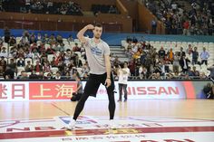 a man standing on top of a basketball court