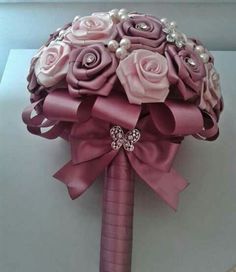 a bridal bouquet with pink roses and pearls