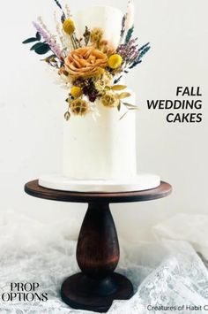 a white wedding cake with flowers on top and the words fall wedding cakes above it