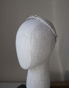 a white headpiece on a mannequin's head wearing a tiara