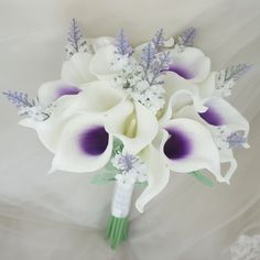 a bridal bouquet with purple and white flowers