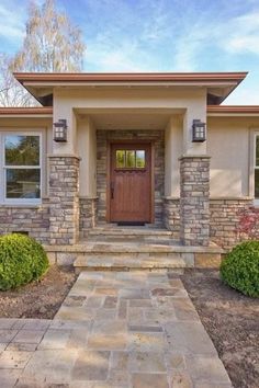 the front entrance to a home with steps leading up to it's entry door