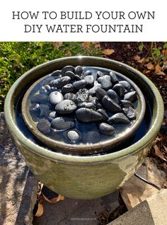 a bowl full of rocks with text overlay that reads how to build your own diy water fountain