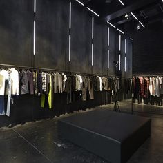 a room filled with lots of clothes hanging on the wall