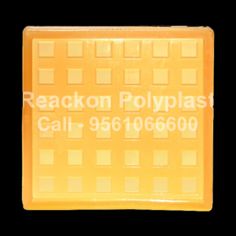 a yellow plastic tray with squares on it