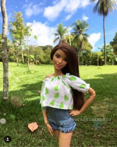 a doll is standing in the grass with her hands on her hips and looking at the camera