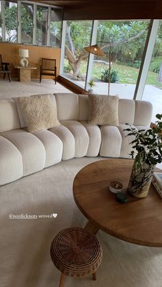 a living room filled with furniture and lots of windows