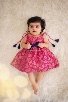 Soft banarasi frock with contrast bow. Closure: Back Zipper with banaras tie up Lining: cotton Care: Hand wash with mild detergent/Shampoo. Do not soak. Dry inside out in shade. It might bleed on coming in contact with water for the first time. Disclaimer: Most of our products are handcrafted and may have slight differ Baby Frock Design Cotton, Kids Pattu Frock Designs, Baby Frock Design, Frock For Baby Girl, Kids Frock Design, A Line Frock For Kids, Frock For Kids, Baby Frock, Kids Frock