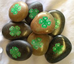 six rocks with shamrocks painted on them