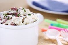 a white bowl filled with food sitting on top of a table