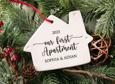 a personalized ornament hanging from a christmas tree