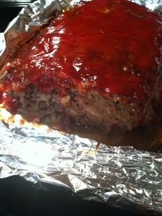 the meatloaf is covered in ketchup and ready to be served on the grill