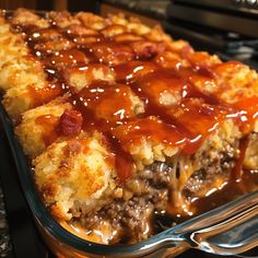 a casserole dish with meat, cheese and sauce on top is ready to be eaten