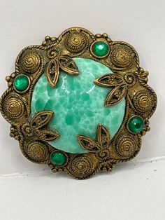 Lovely vintage example Peking glass Czech brooch , hook clasp rare to find in original condition with all four green crystal stones in place Green Costume Jewelry Brooches For Gifting, Green Costume Jewelry Brooches For Gift, Green Round Brooch For Gift, Green Round Brooches For Gift, Luxury Unique Jewelry Made Of Czech Glass, Green Round Brooch Jewelry, Green Costume Jewelry Brooch For Collectors, Luxury Multicolor Czech Glass Jewelry, Green Round Brooch