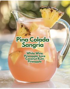 a pitcher filled with pineapple sangria sitting on top of a table