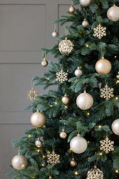 a christmas tree with gold and white ornaments