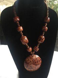 "Brown and beige marbled resin statement necklace. The central pendant is 2.75\" and it's surrounded by matching beads of different shapes and sizes. Very earthy, organic career look, but also works with jeans. Measures 20\" long. Also, please take a look at my storefront at: https://www.etsy.com/shop/FabFinds42?ref=seller-platform-mcnav I have a wide selection of one-of-a-kind items, from clothing and toys to home decor and gift items, and I add new things almost every day." Rustic Brown Necklace With Large Beads, Brown Beaded Round Pendant Necklace, Artisan Brown Necklace With Large Stone, Handmade Brown Resin Jewelry, Bohemian Resin Round Pendant Necklace, Unique Brown Necklace With Large Beads, Earthy Brown Hand-strung Beaded Necklaces, Unique Brown Resin Necklaces, Brown Multi-strand Necklace With Large Beads